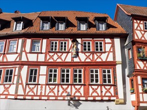 Half-timbered house in the main street with row of half-timbered houses