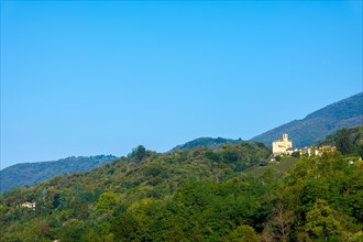 Church in Castelrotto and Village on Mountain Range and Valley with Sky in a Sunny Summer Day in Malcantone