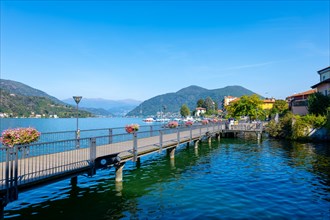 Elevated Walkway on Lake Lugano and City with Mountain in a Sunny Summer Day in Porto Ceresio