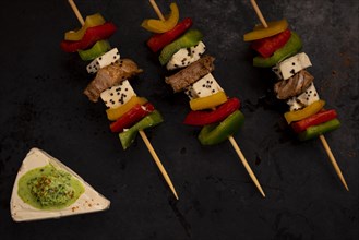 Delicious skewer and cheese with green sauce
