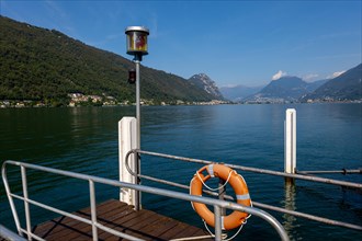 Pier in Brusino Arsizio on the Waterfront in a Sunny Summer Day on Lake Lugano and Mountain in Brusino Arsizio