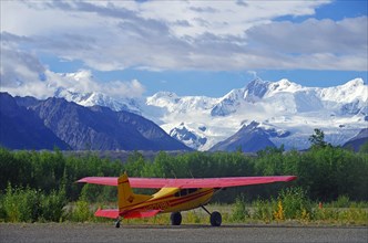 Small bush plane in front of huge glaciers