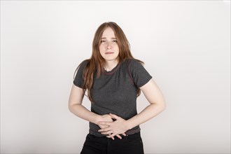 Young redhead woman with tummy pain