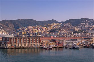 Port entrance of Genoa with its colourful houses and ships in the foreground Genoa Italy Europe
