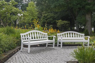 Two white park benches