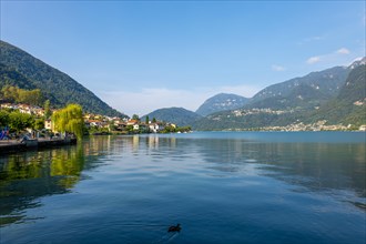 Waterfront in City of Riva San Vitale with Mountain View on Lake Lugano in a Sunny Summer Day in Riva San Vitale