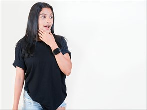 Shocked young girl looking at a promotion to the side. Amazed people with hand on chin looking at blank space. Surprised teen girl looking at an advertisement to side