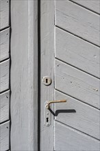 Grey wooden door with lock