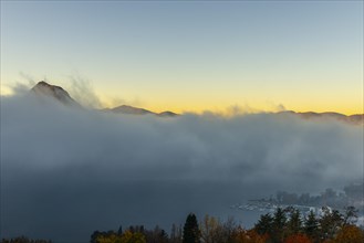 Mountain Peak San Salvatore Above Cloudscape and Lake Lugano with Sunlight and Clear Sky in City of Lugano