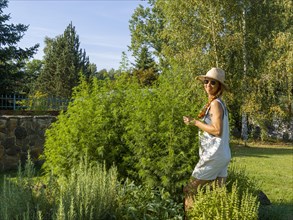 Woman in herb bed