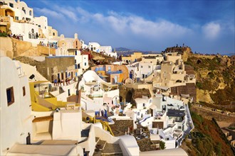 Byzantine castle ruins on hilltop and traditional white houses of Oia village