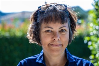 Headshot on a Happy Smiling Woman with Eyeglasses Looking at Camera in a Sunny Day in Switzerland