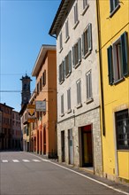 City Street in Porto Ceresio and Church Tower in a Sunny Summer Day in Porto Ceresio