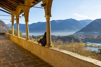 Woman Enjoy Mountain View in a Sunny Winter Day From Church dei Santi Quirico e Giulitta in Lugano