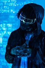 Vertical studio photo with blue neon lights of a futuristic man with augmented reality glasses
