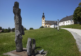Wooden sculptures at the Stations of the Cross on Kirchberg with parish church