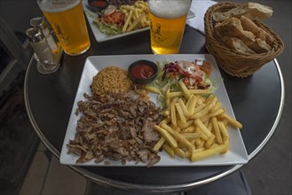 Giros served with fries and rice in a bistro