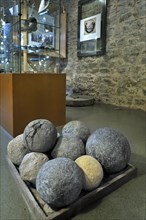 Stone cannonballs in exposition room of the medieval Franchimont Castle
