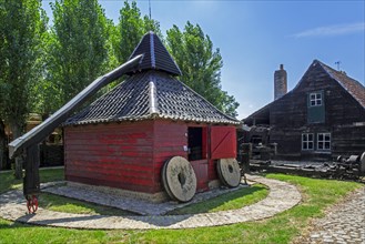 Old Flemish wooden horse mill which uses animal power for grinding grain at the open air museum Bachten de Kupe