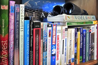 Collection of travel guides about worlwide holiday destinations on a bookshelf