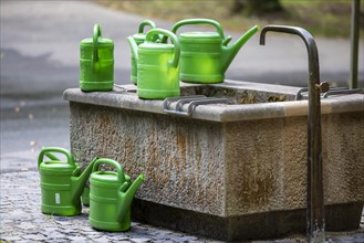 Watering place with watering cans for grave maintenance