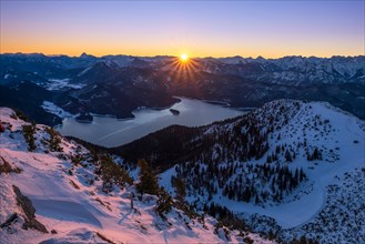 Winter sunrise over Lake Walchen with view of the Alps