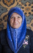 Close-up portrait of Turkish woman wearing blue headscarf