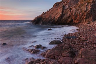 Rocks on the beach and cliffs at sunset along the rocky coast at Josefinelust
