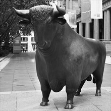 Figure Bull in front of the Frankfurt Stock Exchange