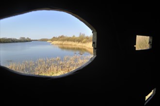 View from bird hide over lake in the nature reserve Parc du Marquenterre at the Bay of the Somme