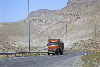 Truck on motorway from Mashhad to Turkmenistan through the Karakum Desert in Iran