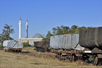 Minarets of the Turkish Islamic Fatih Mosque of immigrant workers and wagons of the coal mine museum at Beringen