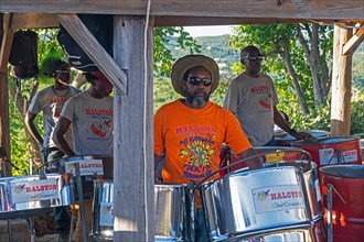 Traditional steel drum band playing steelpans at Shirley Heights on the south coast of the island Antigua