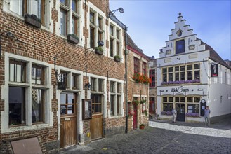 Cobbled alley with restaurants in the district Patershol in the city Ghent