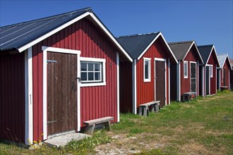 Row of red fishing huts at the fishing village Kappelshamn in Gotland