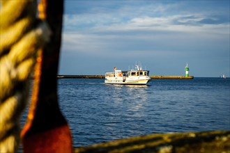 Passenger ferry on the Trave with Travemuende harbour entrance. Hanseatic City of Luebeck
