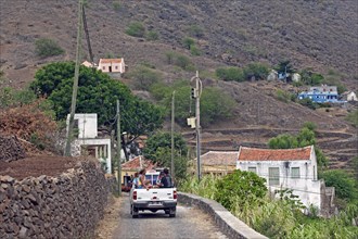 Tourists and locals transported in the back of pickup truck in rural countryside on the island Sao Nicolau
