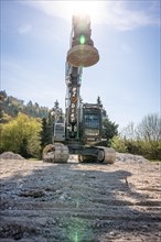 Black Liebherr crawler excavator with magnet recycling on demolition site