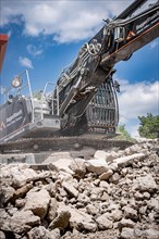 Black Liebherr crawler excavator for demolition recycling on construction site