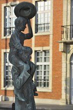 Statue of Flemish author Ernest Claes carrying De Witte van Zichem on his shoulders