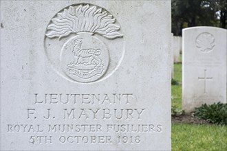 Royal Munster Fusiliers regimental badge on headstone at Cemetery of the Commonwealth War Graves Commission for First World War One British soldiers
