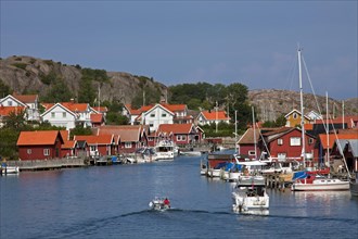 Red wooden boat huts in the harbour at Hamburgsund