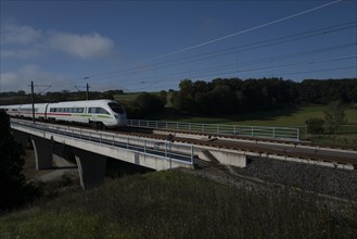 A high-speed train crosses the state of Bavaria on a sunny morning. Luetzelbuch