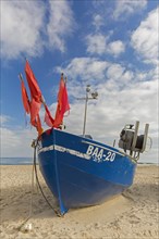 Blue fishing boat on the beach along the Baltic Sea at Baabe on the Island Ruegen
