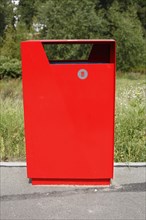 Red metal public waste bin