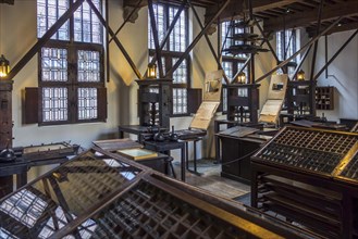 Print shop showing 18th century type cases and 17th century printing presses in the Plantin-Moretus Museum