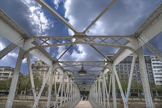 Old iron bridge for pedestrians over the Seine
