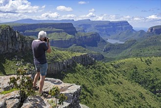 Western tourist at Lowveld viewpoint looking over the Blyde River Canyon