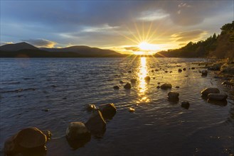 Loch Morlich and Cairngorm Mountains at sunset
