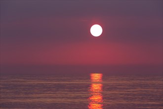 Seascape showing orange sunset over the Wadden Sea